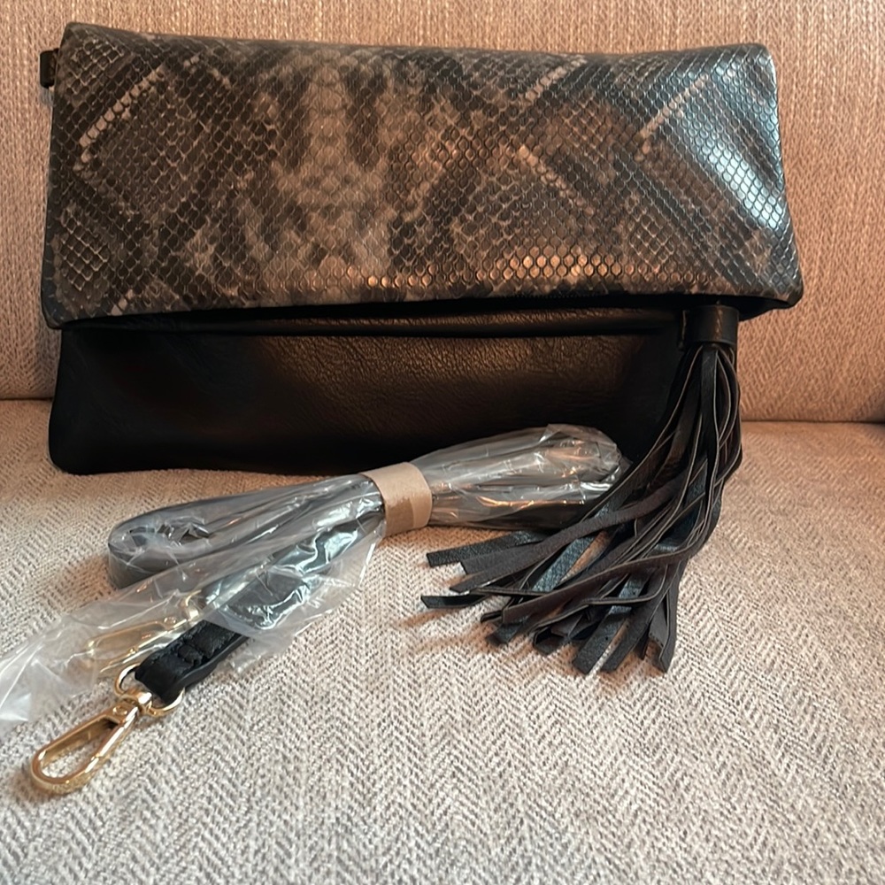 New and never worn snakeskin clutch with optional shoulder strap!